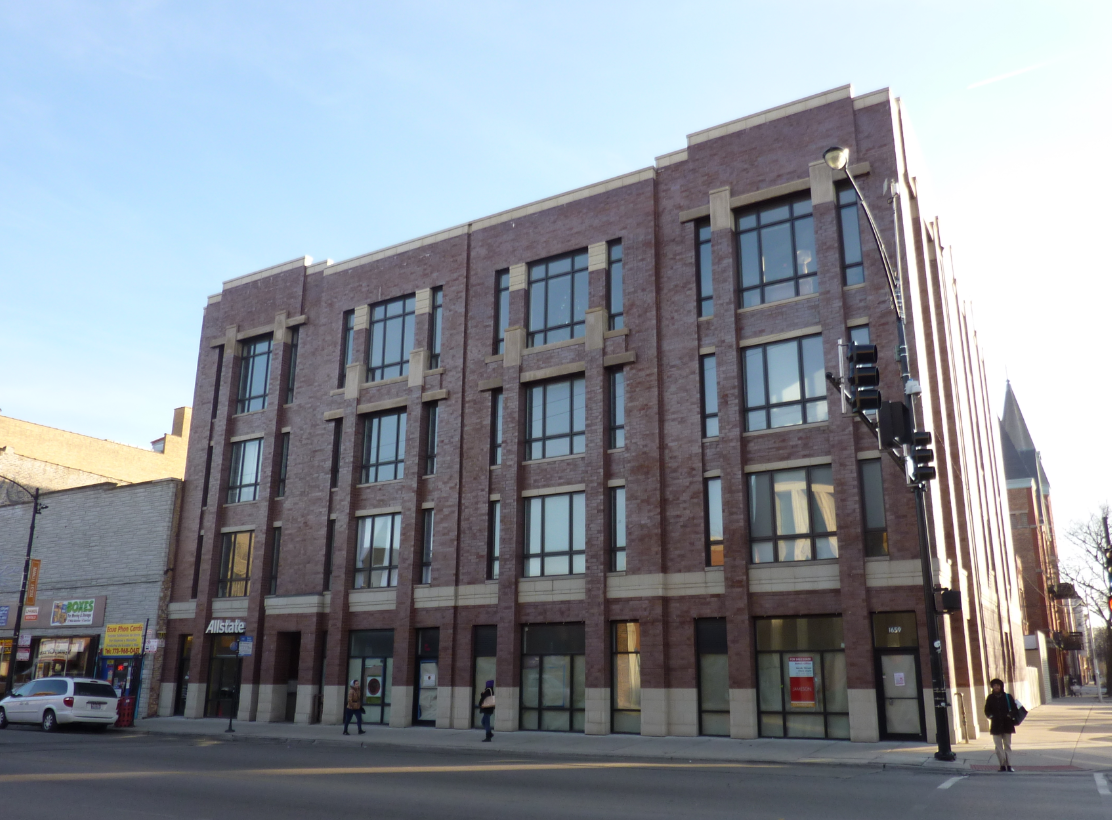 a large brick building on the corner of a city street